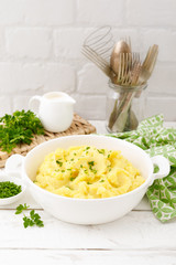 Mashed potato with butter and milk on table