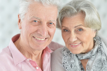 Portrait of happy beautiful senior couple sitting on couch