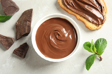 Flat lay composition with tasty chocolate mousse, bread and mint on table