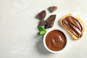 Flat lay composition with tasty chocolate mousse, bread and mint on table. Space for text
