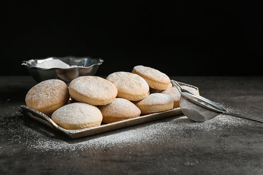 Tray of traditional cookies for Islamic holidays and strainer on table. Eid Mubarak