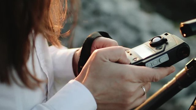 Photographer professional makes metering exposure meter.