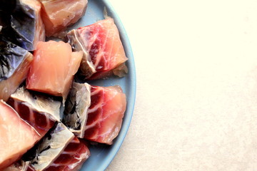 pieces of salted  fish close-up on a blue plate