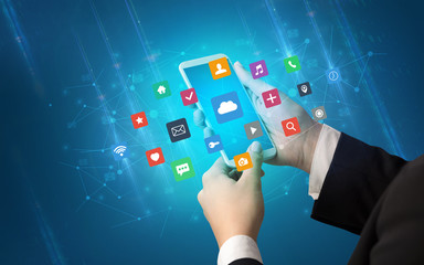 Female hand using smartphone with colorful application icons around