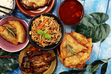 Assorted Chinese food set. Chinese noodles, fried rice, peking duck, dim sum, spring rolls. Famous Chinese cuisine dishes on table. Chinese restaurant