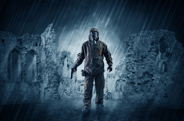 Fototapeta premium Hazard, menace man in a ruined crumbly building with arms on his hand 