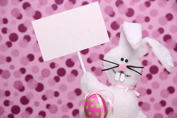 Easter bunny holding a blank card