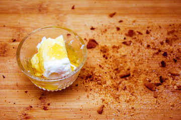 Honey with cream, Honey and cream in bowl with breadcrumbs on cutting board