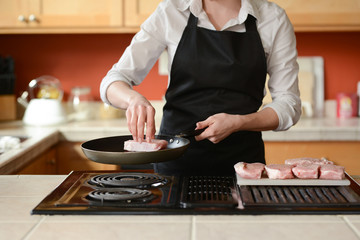 The chef prepares fresh pork steaks in the kitchen, home cooking menu. culinary recipes. restaurant menu. Delicious food