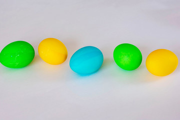Easter eggs multicolored isolated on white background. Minimal easter concept. Happy easter card with copy space for text. Top view, flat.