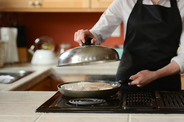 The chef prepares fresh pork steaks in the kitchen, home cooking menu. culinary recipes. restaurant menu. Delicious food, recipes and cooking