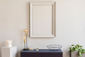 Scandinavian and design home decor with mock up gray poster frame, navy blue shelf with stylish accessories, lamp and plants. Stylish and minimalistic room interior.