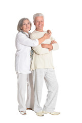 Senior couple hugging isolated on white background, full length