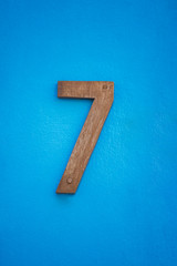 wooden figure seven number on blue wall