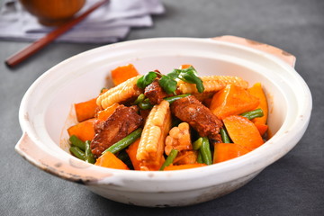 beef stew with carrots and onions in bowl