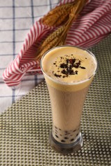 cup of coffee with whipped cream on wooden background