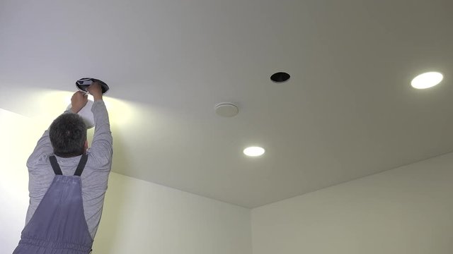 handyman connect and install led light panel into ceiling hole