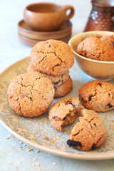 Healthy pastry. Homemade oatmeal cookies with dried cranberries and coffee in cerve