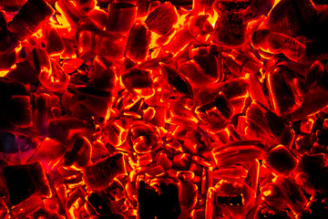 Glowing Hot Charcoal Briquettes Close-up Background Texture