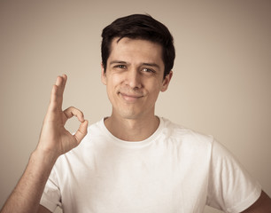 Portrait of young handsome cheerful man with smiling happy face. Human expressions and emotions