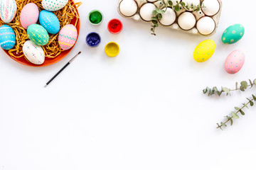 Easter celebration with colorful eggs on white background top view mock up