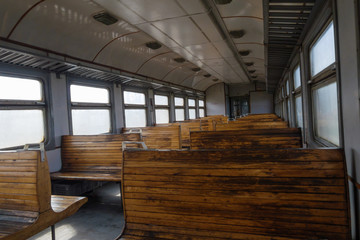 Salon electric train with empty wooden seats