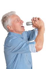 Portrait of senior man in singing with microphone