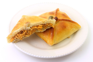 Chicken esfiha of arabic origin traditionally adapted for brazilian cuisine on plate on white background
