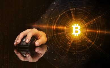 Hand using wireless mouse with cryptocurrency concept on dark background