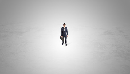Young businessman standing alone in the middle of an empty space
