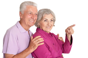 Close up portrait of senior couple pointing isolated on white background