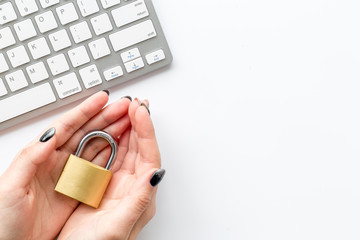 protect information from cyber attack with locker in hands and keyboard on white background top view mockup