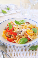 Italian cuisine. Neapolitan pasta. Farfalle with mushrooms and belle pepper and cheese