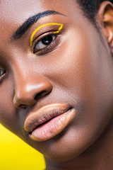 Cropped view of beautiful african american woman isolated on yellow