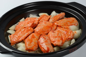 frying pan with sausage and potato ragout on white background