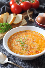 Italian cuisine. Stracciatella tomato soup: parsley, eggs and parmesan cheese