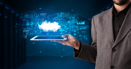 Hand holding tablet with cloud technology and dark concept
