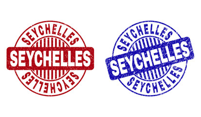 Grunge SEYCHELLES round stamp seals isolated on a white background. Round seals with grunge texture in red and blue colors. Vector rubber watermark of SEYCHELLES text inside circle form with stripes.