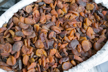 Naturally dried apricot fruit in the sun. organic dried apricots sold in sacks