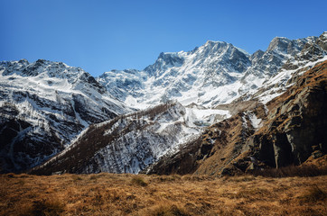 Mountain hiking path trough the massif of the Monte Rosa (Piedmont, Italy) to the Sella refuge, walked at the end of winter, with a full view of the glaciers