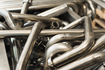 Background of metal twisted pipes. Brilliant clean indirect tubes.  Abstract of Pipe bending...
