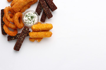 a dish for beer with a different snack on a wooden table