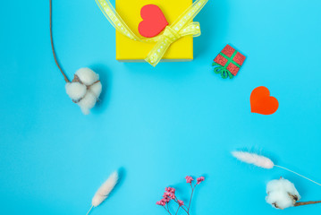 Mother's Day and gifts for loved ones, yellow box and yellow ribbon, dried flowers and hearts