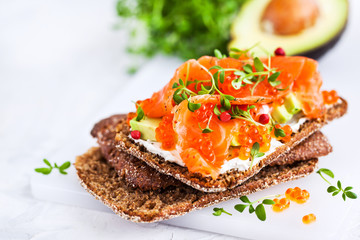 Salted salmon, red caviar, avocado and cream cheese rye crisp toast