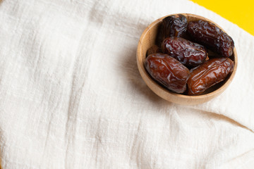 Ramadan Kareem Festival, Dates at bowl with rosary on yellow background