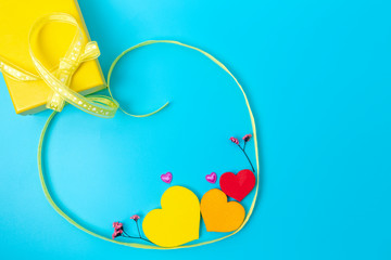 Mother's Day and gifts for loved ones, yellow box and yellow ribbon, dried flowers and hearts