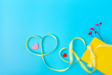 Mother's Day and gifts for loved ones, yellow box and yellow ribbon, dried flowers and hearts