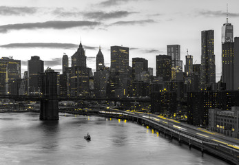 New York City yellow night lights shining on black and white buildings in Manhattan