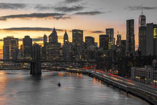 New York City night lights against black and white skyline buildings in Manhattan