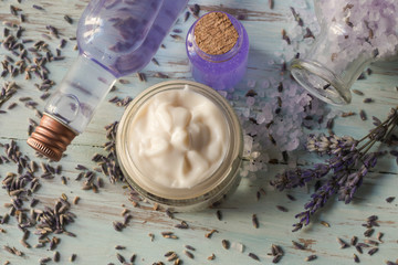 Fototapeta na wymiar Facial cream and tonic of homemade lavender in a glass jar, on a wooden background